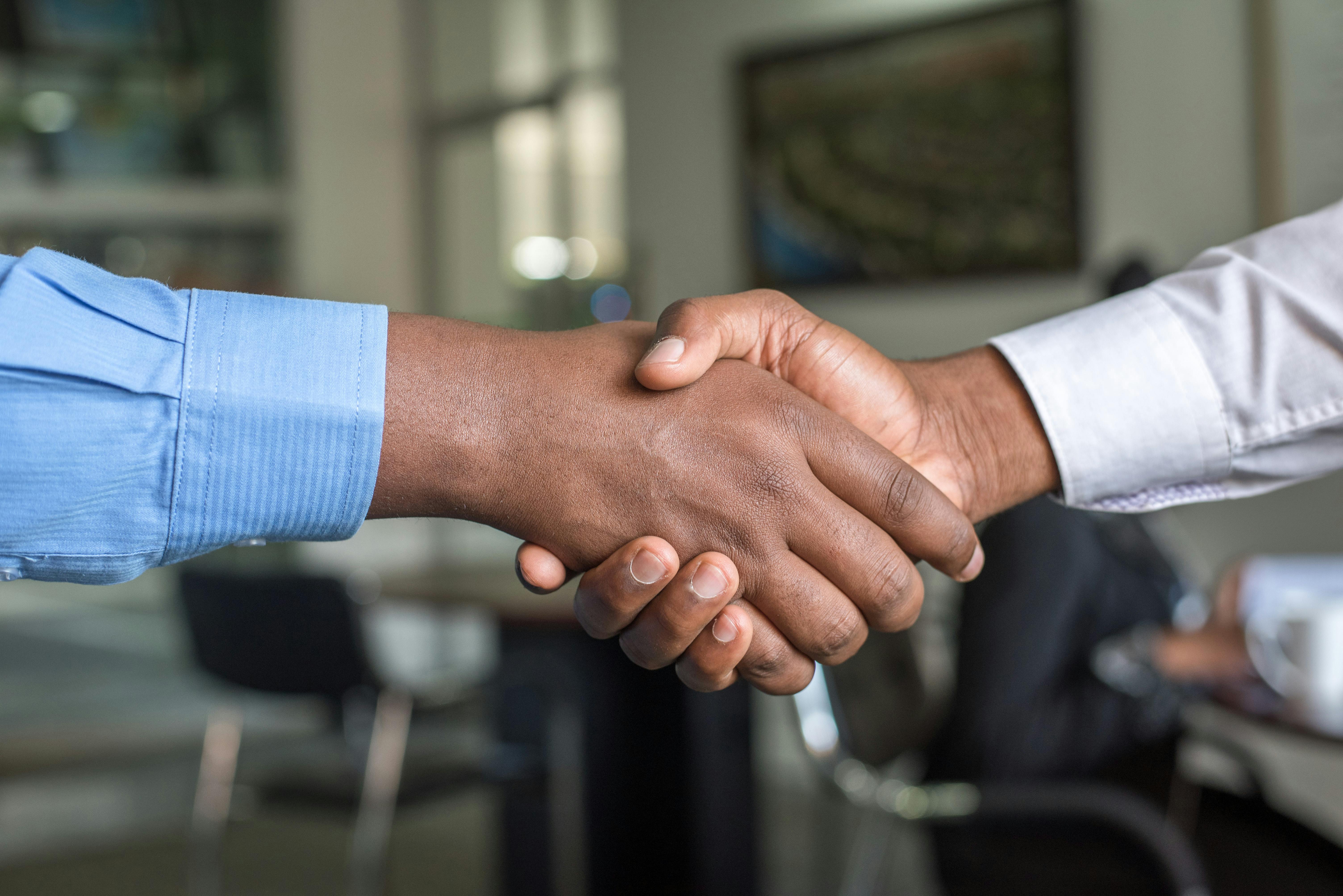Business handshake between E.A.D professionals sealing partnership